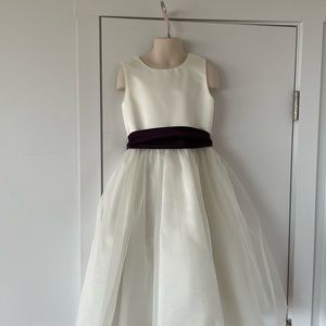 White formal dress with removable eggplant colored sash for a size 6 girl.